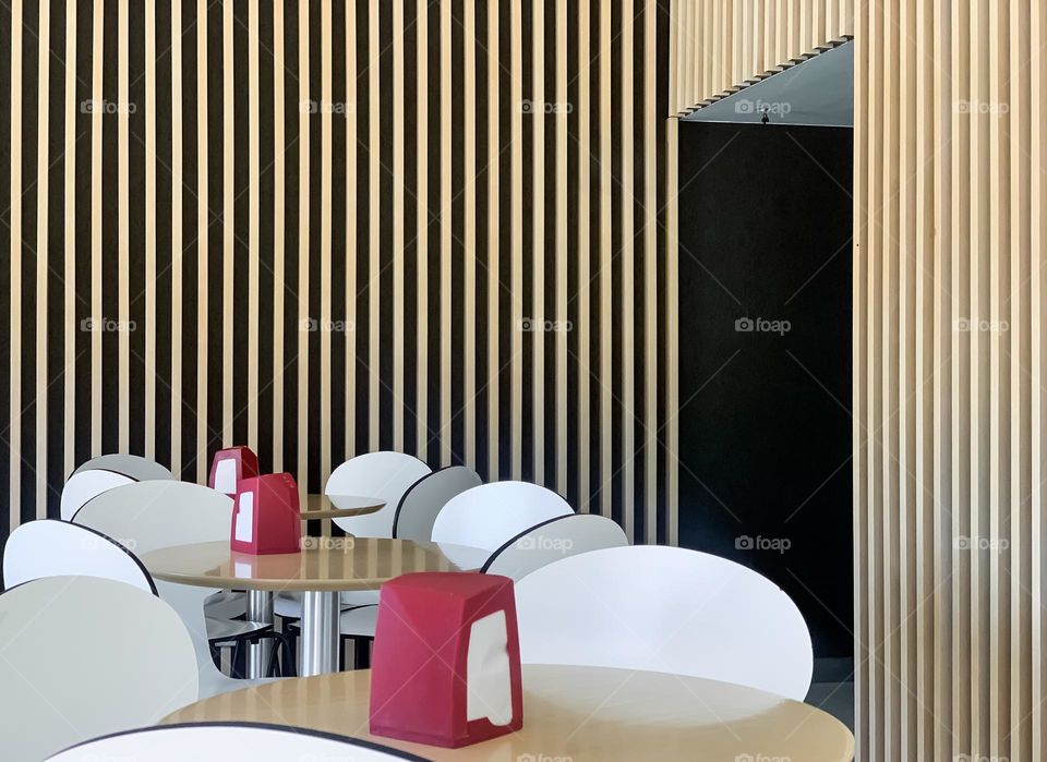 Cafe tables surrounded by wood siding clad walls