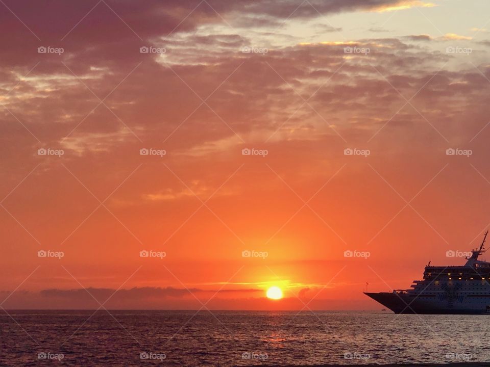 A sunset is always a blessing, especially with such a beautiful sea, sky and ship. 