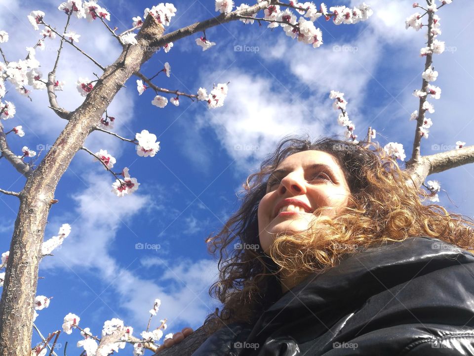 Girl under a flowered tree