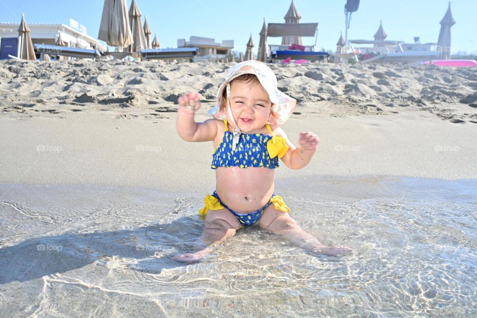 happy little girl by the sea