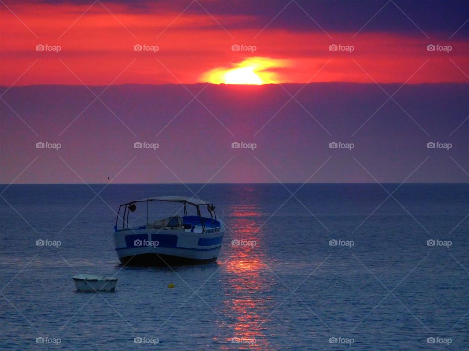Boat in sea during sunset