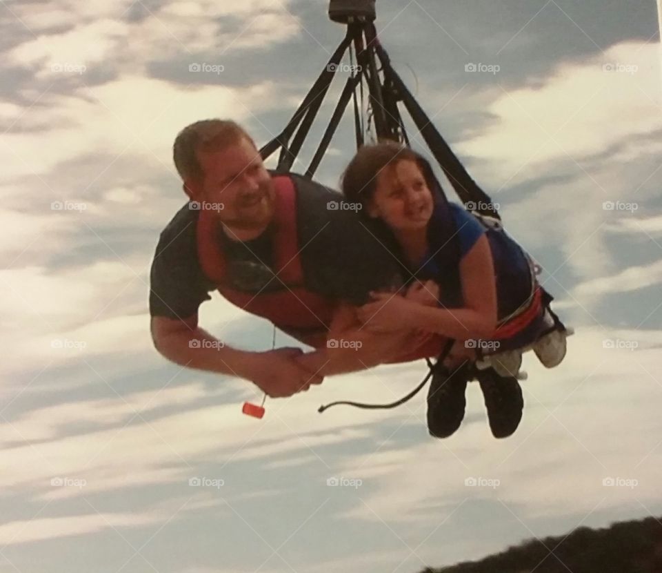 Dad and daughter swinging over the royal Gorge