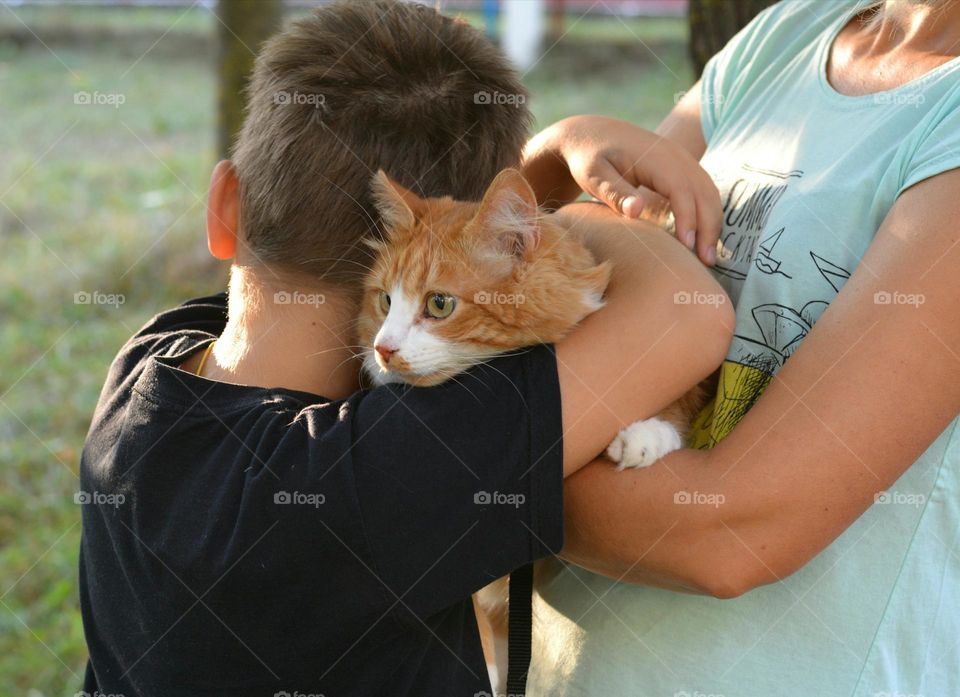 family mother with child boy and cat outdoor, love pet