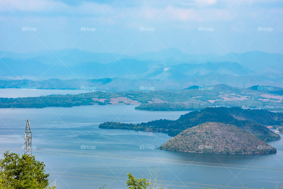 The beauty inside the dam and the houseboat on the bright sky at Sri Nakarin dam , Kanchana buri in Thailand.