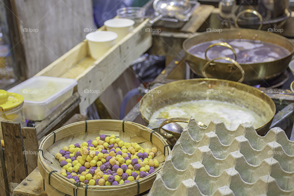 Thai dessert or Bua loi , Dumplings rice ball on bamboo tray and coconut milk.