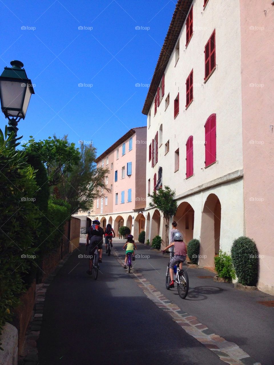 Carefree family cycling through French street