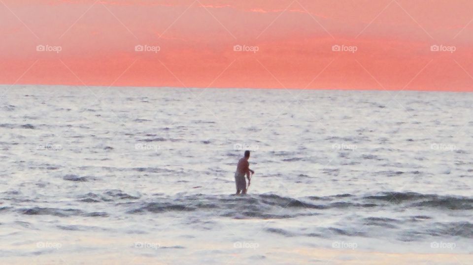 Surfer in sunrise