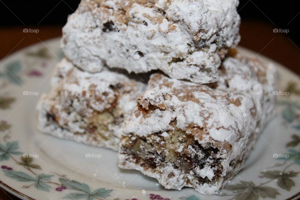 Homemade date nut bars covered in white powdered sugar