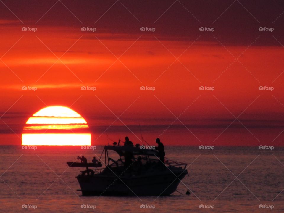 Zoom of the Sun and boat (Praia - Italy ).