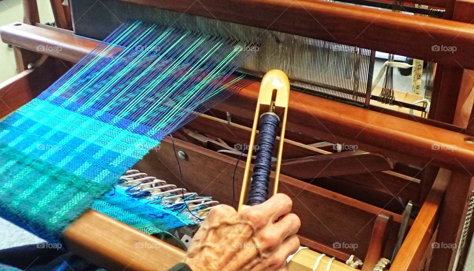 Old woman using a loom