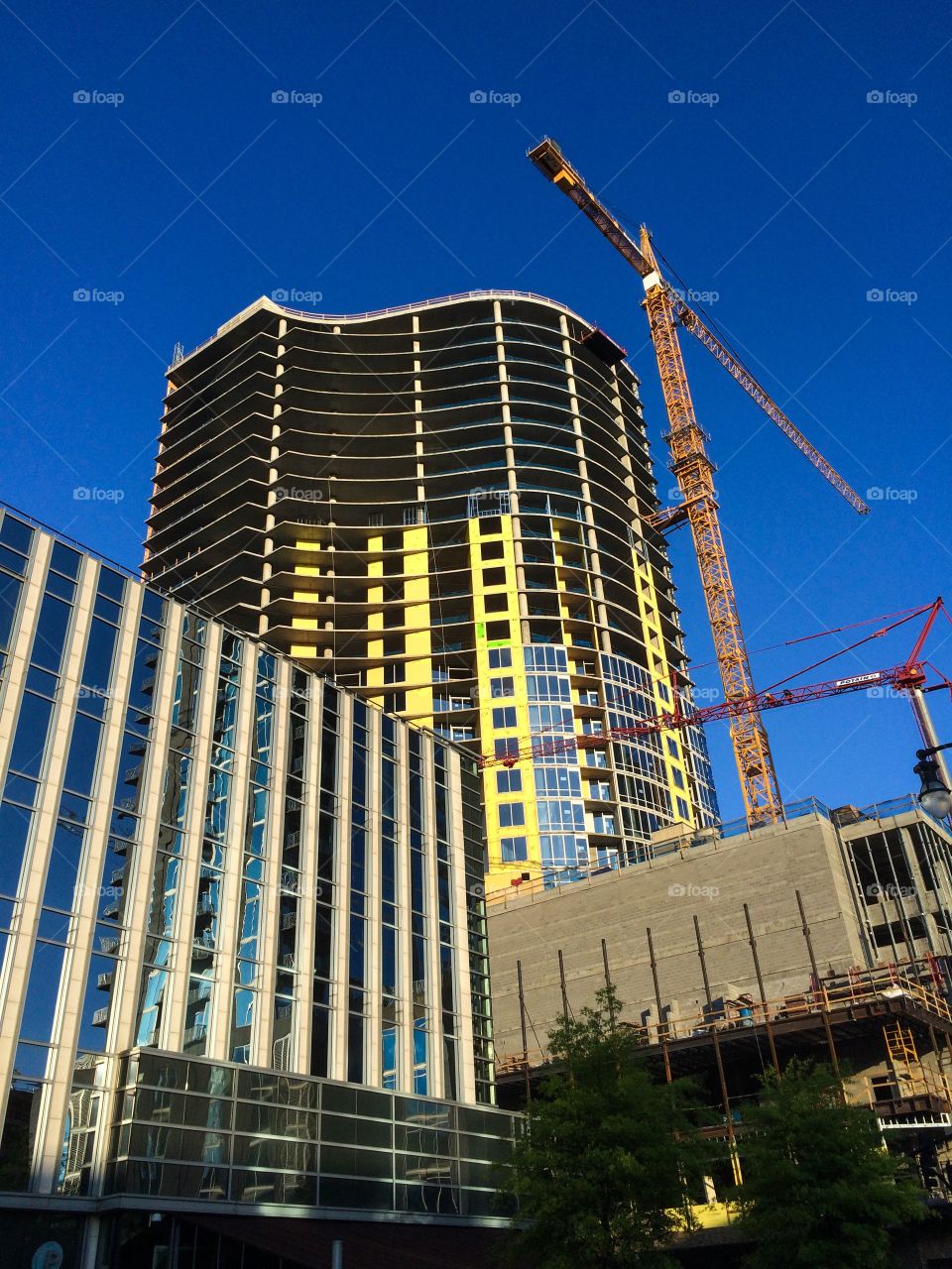 Building under construction with two cranes 