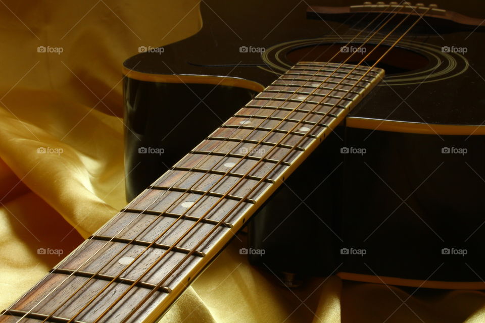 acoustic guitar on Golden textile