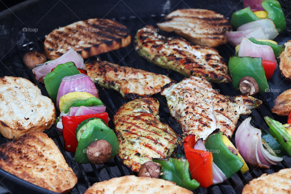 Grilled chicken, vegetables, and bread slices