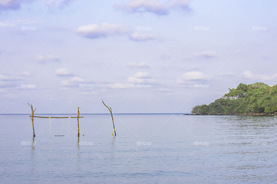 Swing chairs made from wood in the sea Background sky and cloud at Koh Kood, Trat in Thailand.