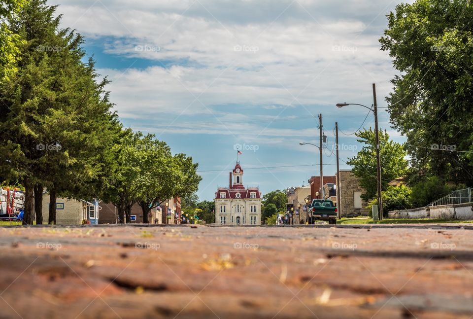 Horizontal photo of the old downtown of Cottonwood Falls, KS with the courthouse at the end of the street (all logos edited out)
