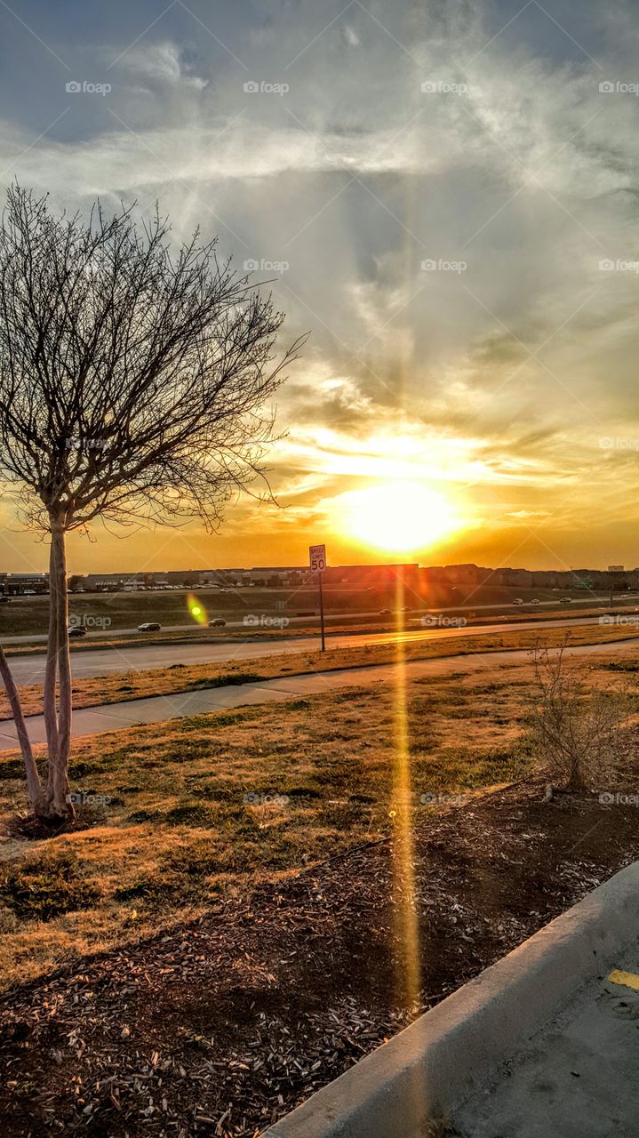 Irving, TX. I was standing in the parking lot overlooking a major highway in Las Colinas. Caught the sun right on time.