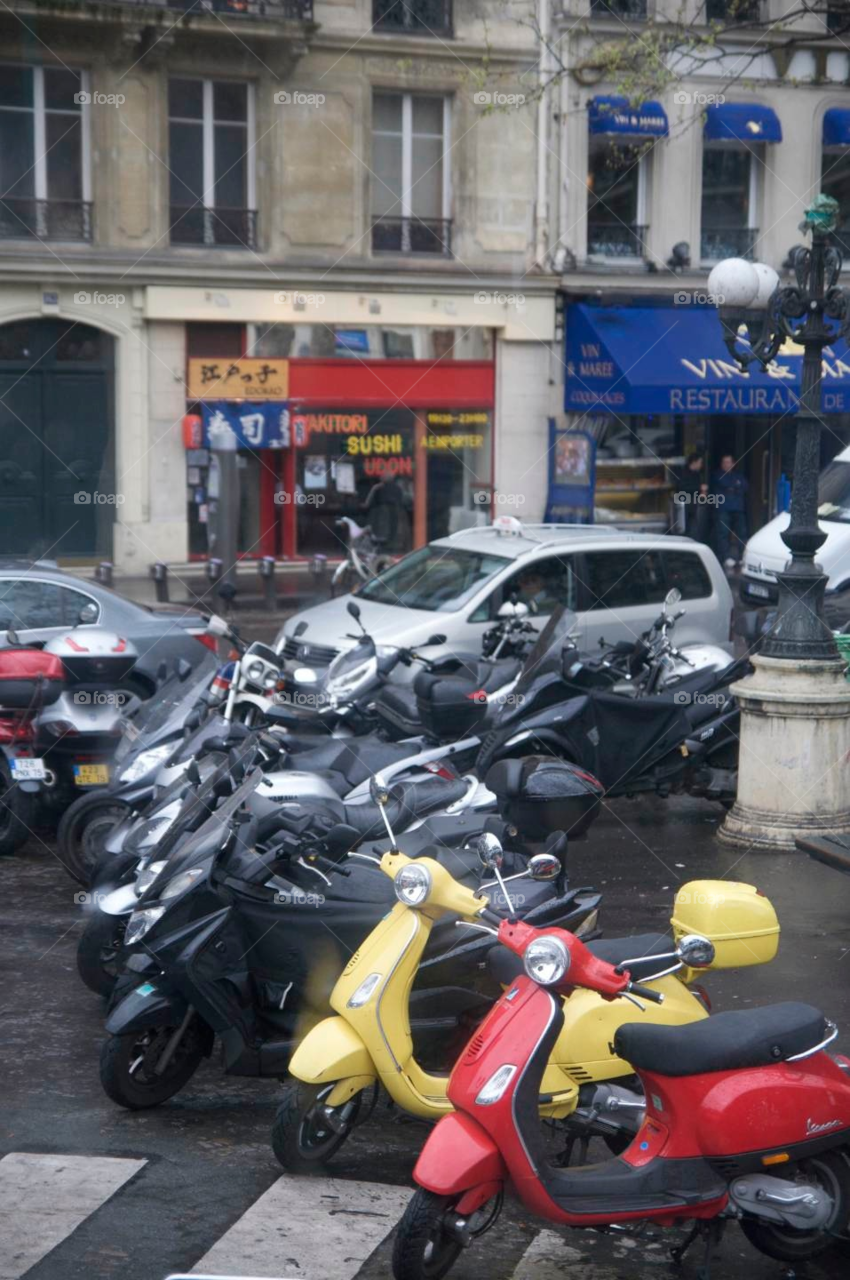 Scooters in the street . Scooters parked on a street in Paris France. 