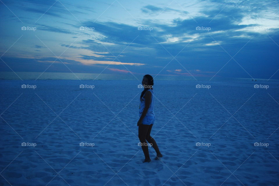 Girl at the beach after sunset