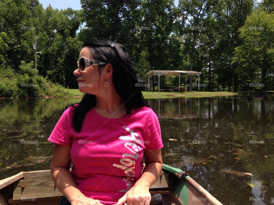 Enjoying a row on a pond with sister. Spending family time