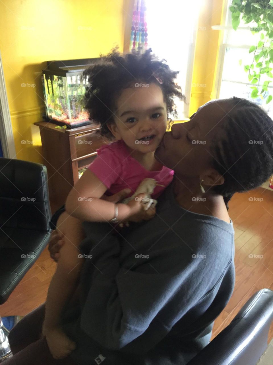 Bumps and Kisses. Carmen with a black eye from overjumping a bench during toddler read time at the library.