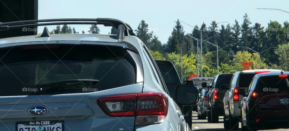 close up view of a long line of cars in stop and go Oregon commuter traffic on a sunny evening