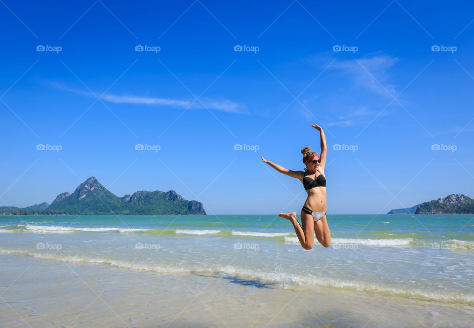 Woman jumping on beach