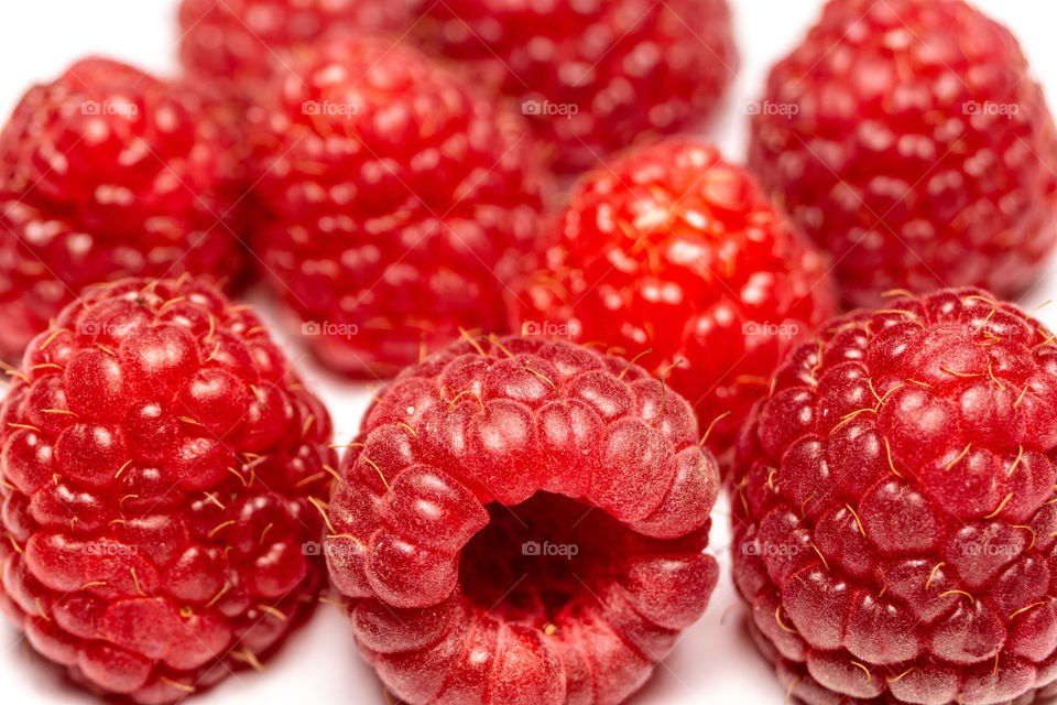 Fresh raspberries on white background. Close up shot