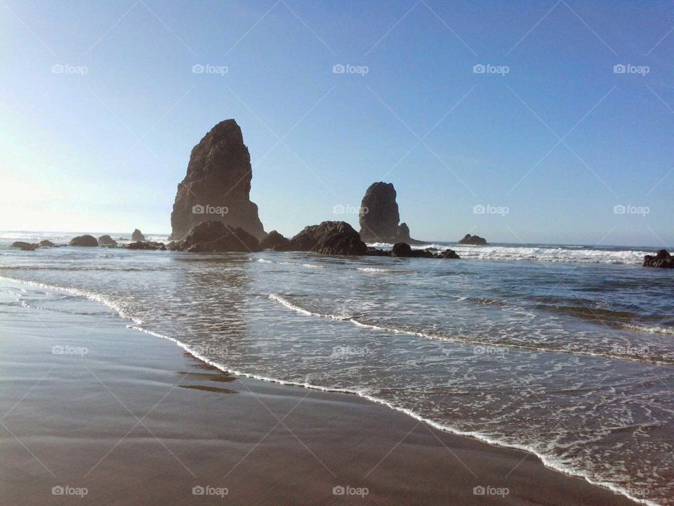An image of rocks on Cannon Beach in Oregon.