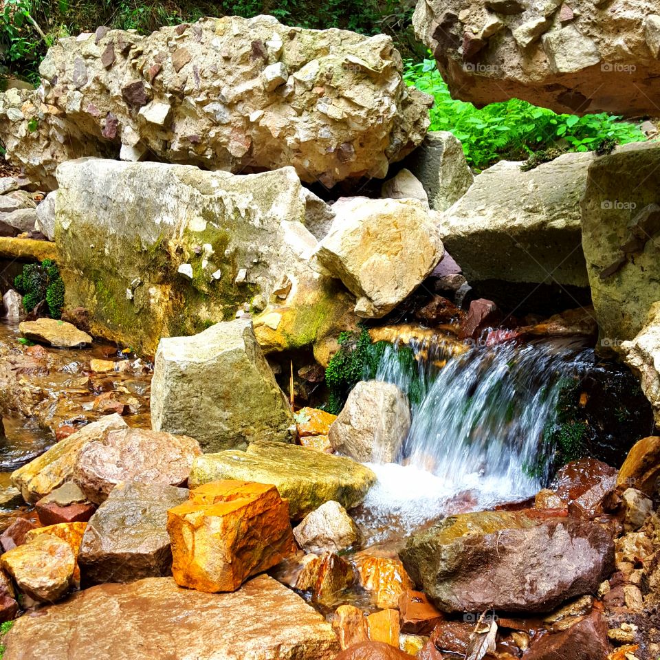 small stream coming out of rocks