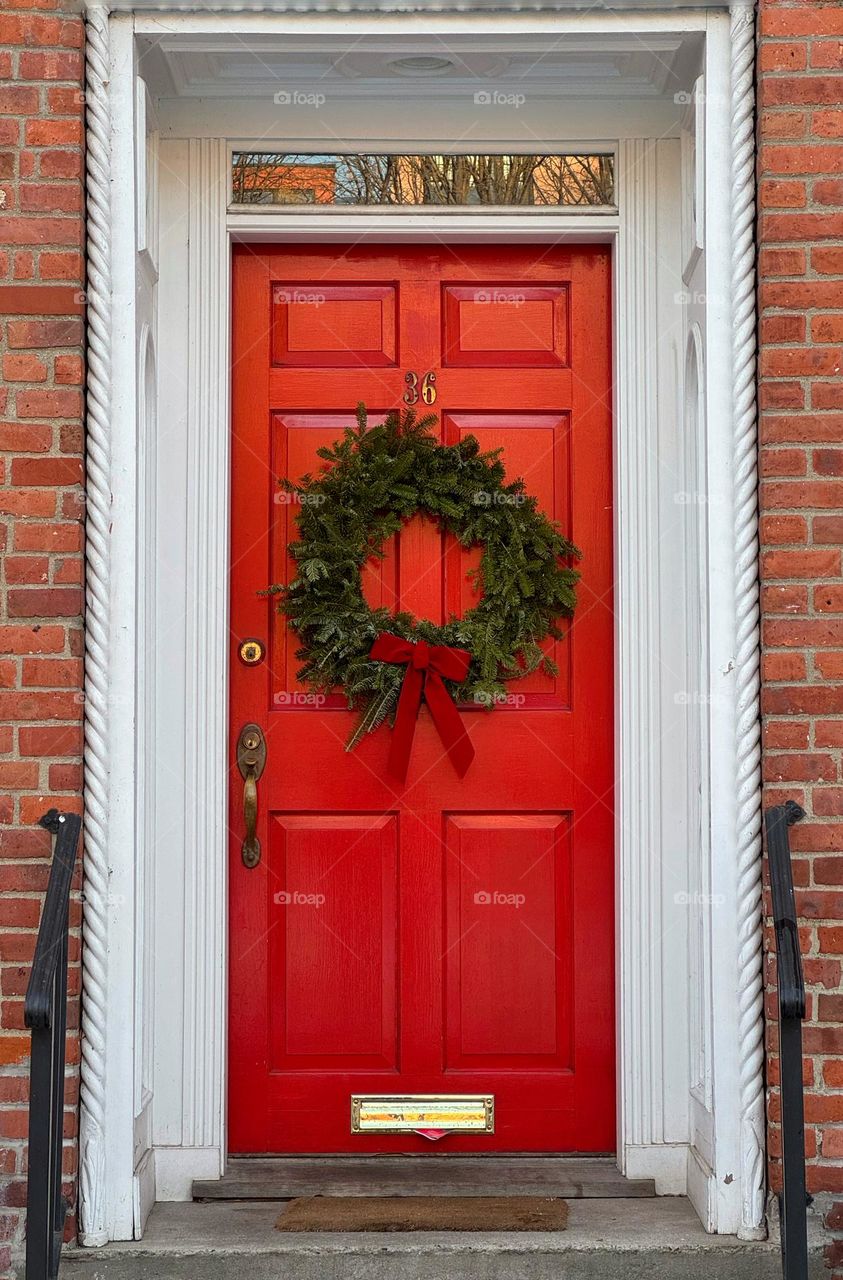 Red door with a Christmas wreath 