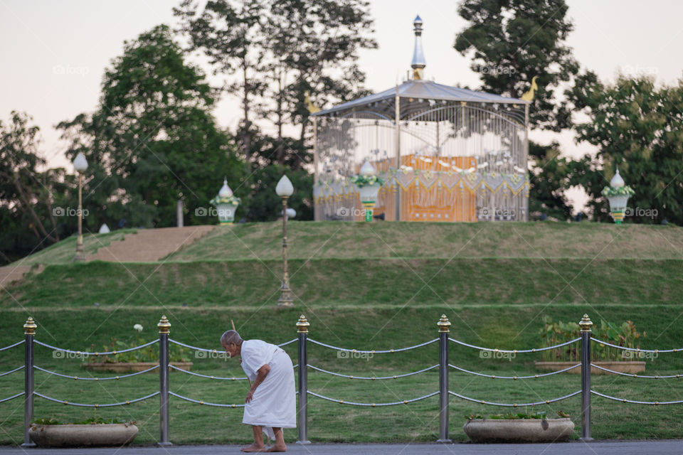 Old woman walk around the monument