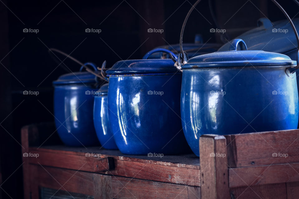 Blue pot on the wooden shelf 