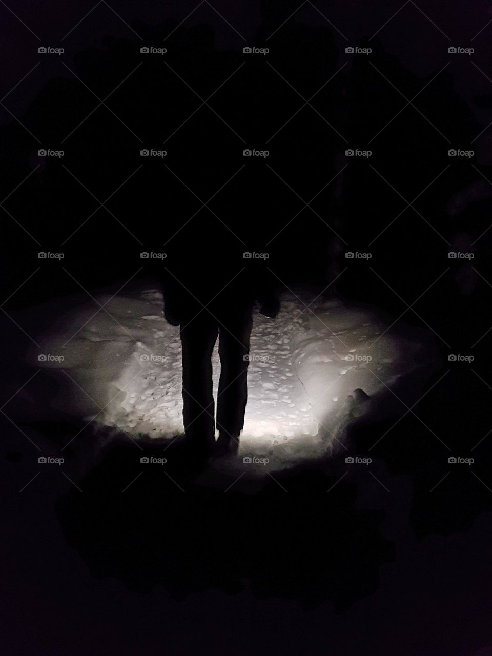 walking in the dark forest with mobil flashlight