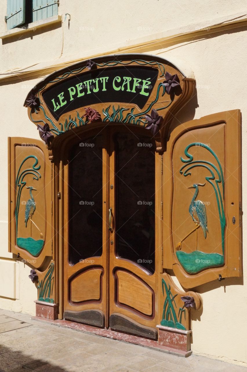 Le Petit Café - old door of a pub in the South of France.