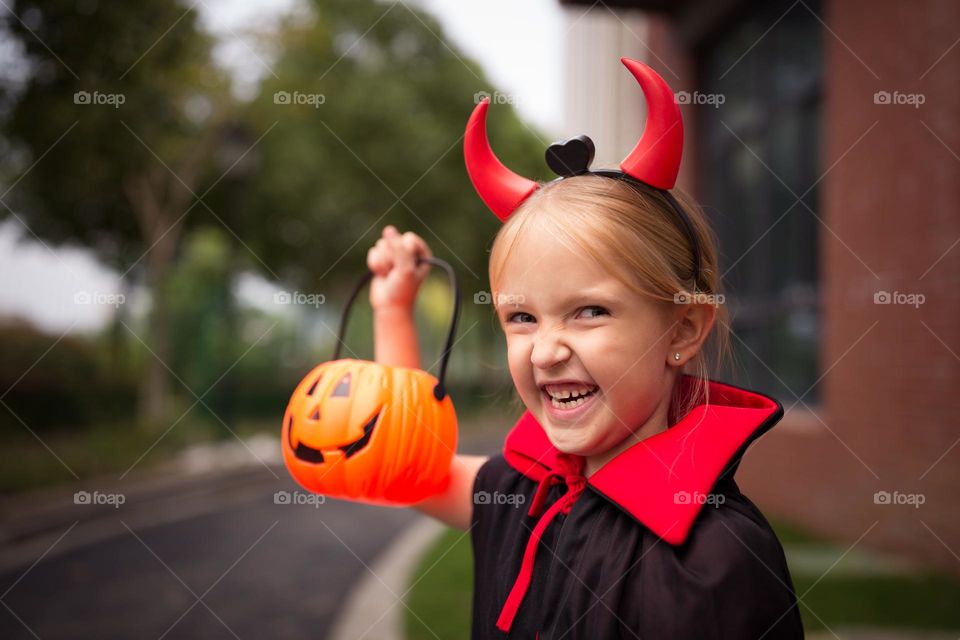 Happy kid celebrating Halloween outdoor 