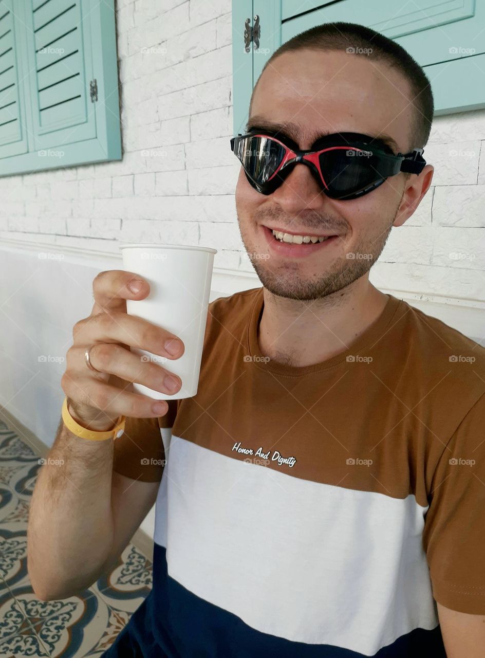 Happy guy in swimming goggles