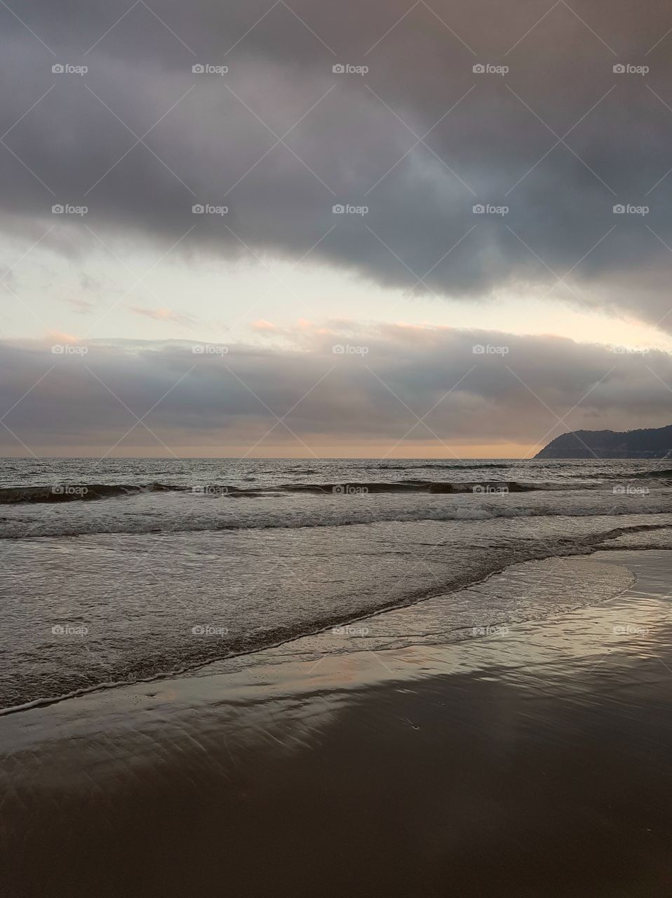 Dramatic, cloudy sky over the sea at sunset