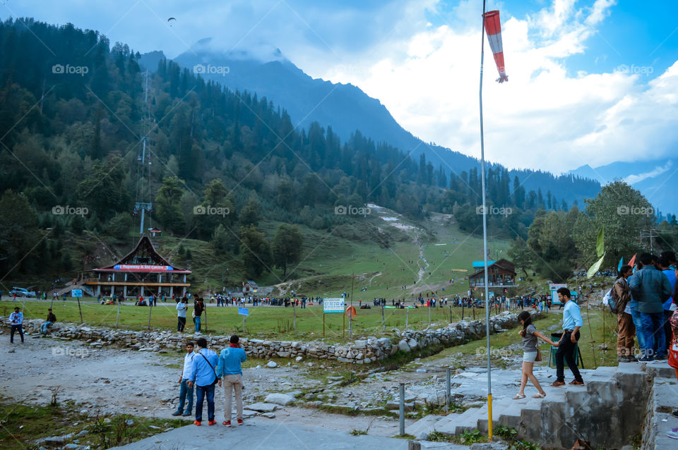 SOLANG VALLEY, MANALI, HIMACHAL PRADESH, India OCTOBER 26 2017: Tourists walking around on ski ground at Paragliding site. In summer famous for adventure sports and winter day it becomes snow covered.