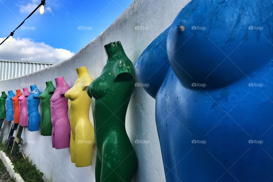 Colourful mannequins on a wall