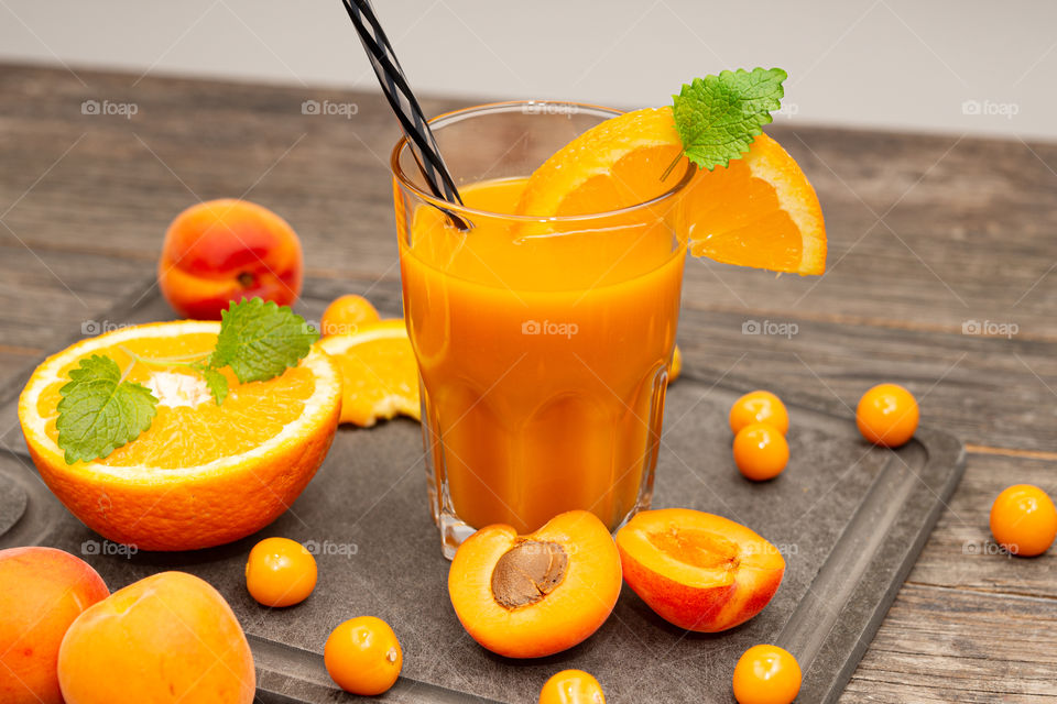 orange juice with apricots and physalis in a glass