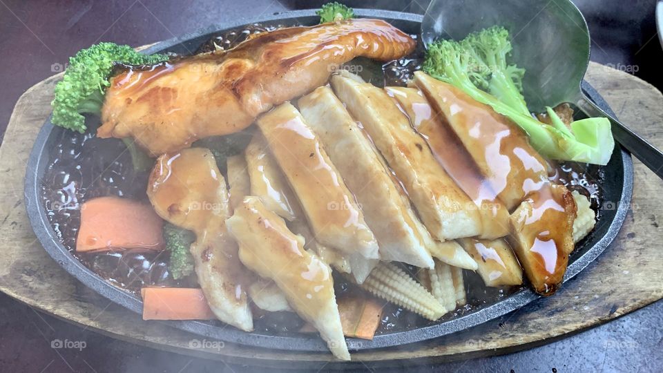 Salmon and chicken teriyaki on sizzling plate