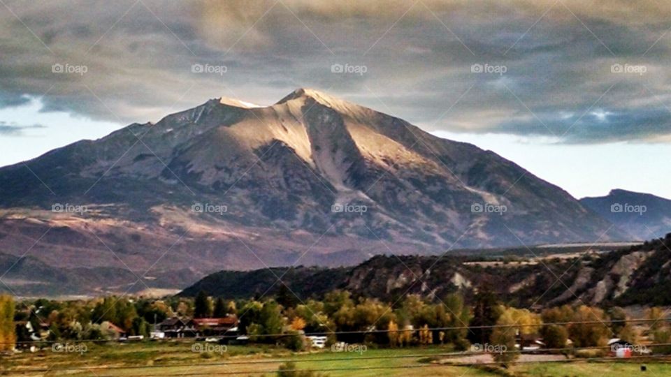 Glorious last rays of the day on the mountain and valley below
