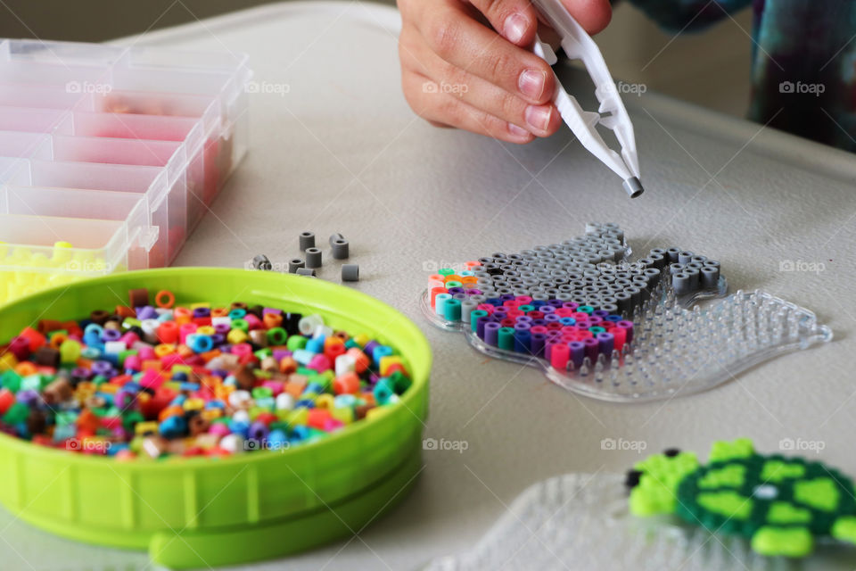 Child creating Fuse Bead picture