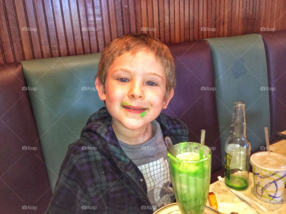 Happy Irish Boy. Young Boy Drinking A Green Milkshake
