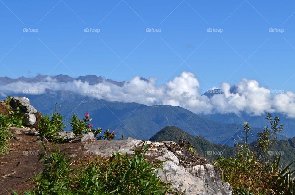 This is what sky walking to the top of Machu Picchu mountain looks like, with panoramic nature views, mountains, clouds and sky. 