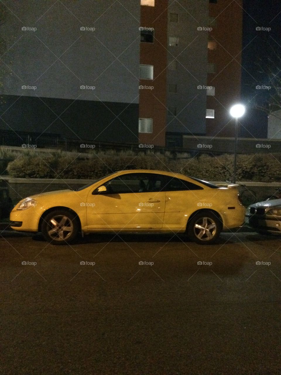 Yellow car parallel parked 
