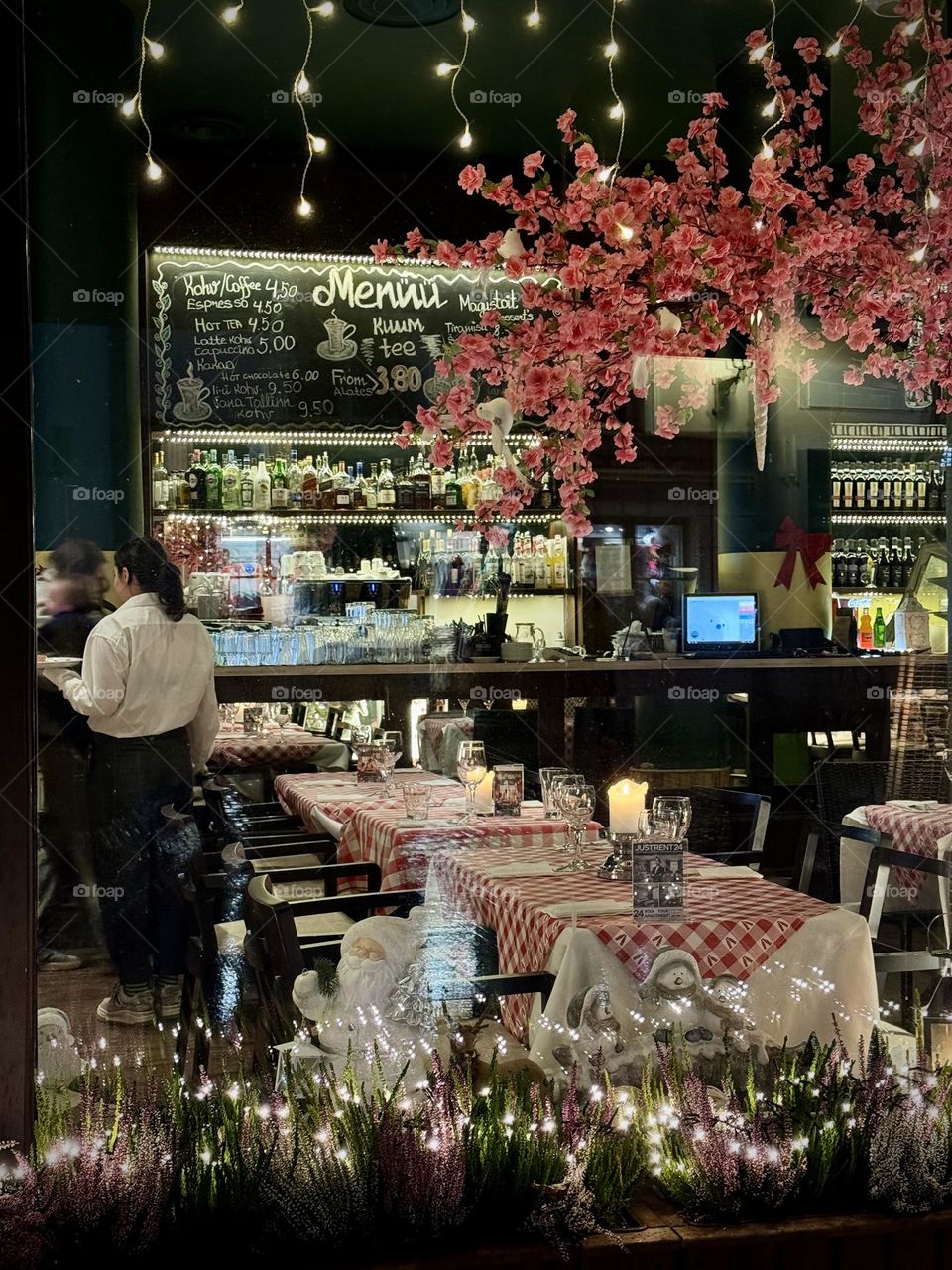 Cozy restaurant interior through the window in the evening