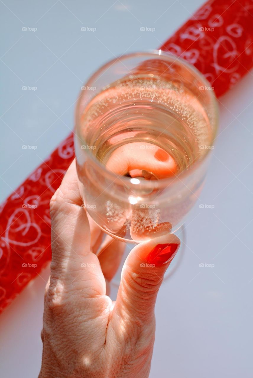 champagne glass in the female hand magenta colour happy New year