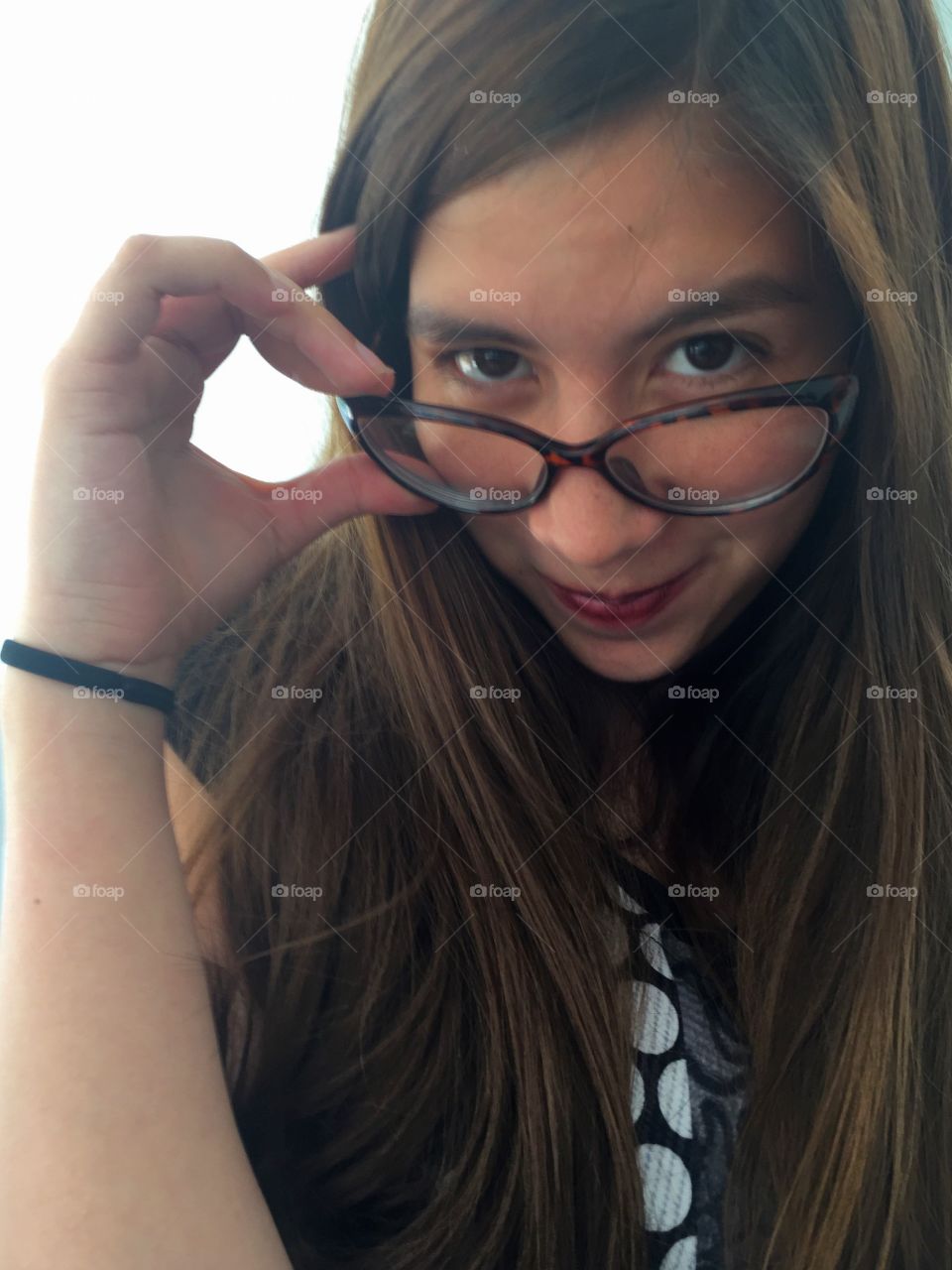 Portrait of girl wearing eyeglasses looking at camera