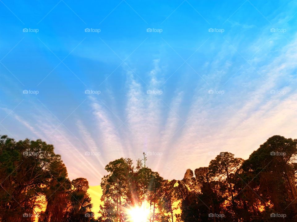 Glowing sunset and radiating cloud formations.